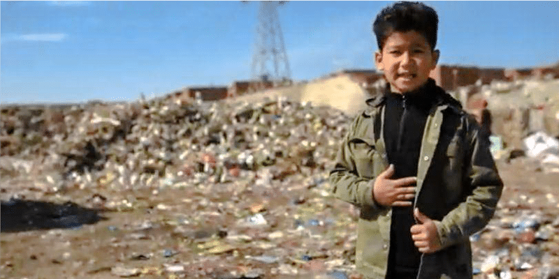 Young Aser Ahmed stands before a landfill, driven to solve waste issues.
